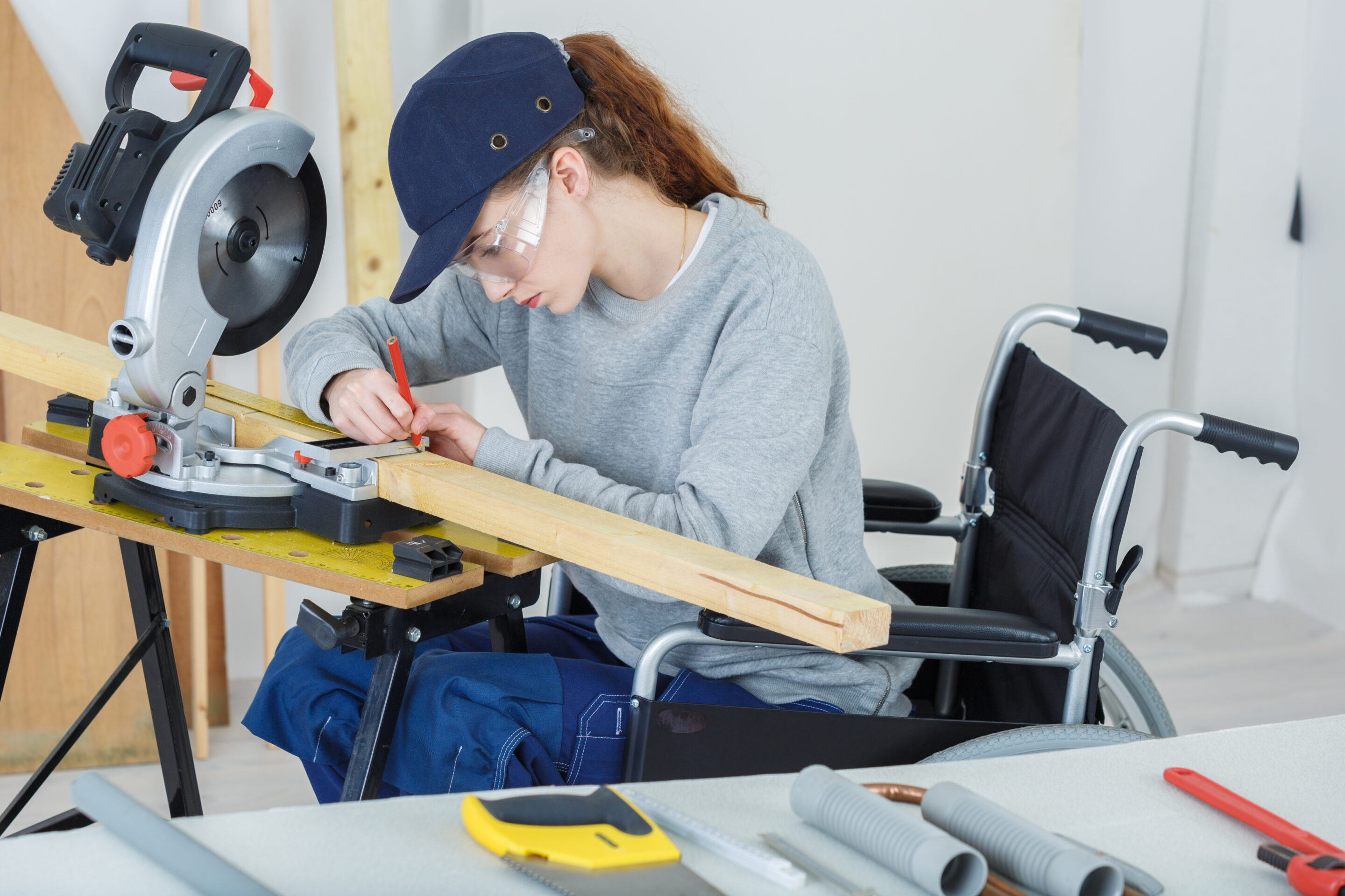 disabled female worker in wheelchair in a carpenters workshop handicap travailleuse